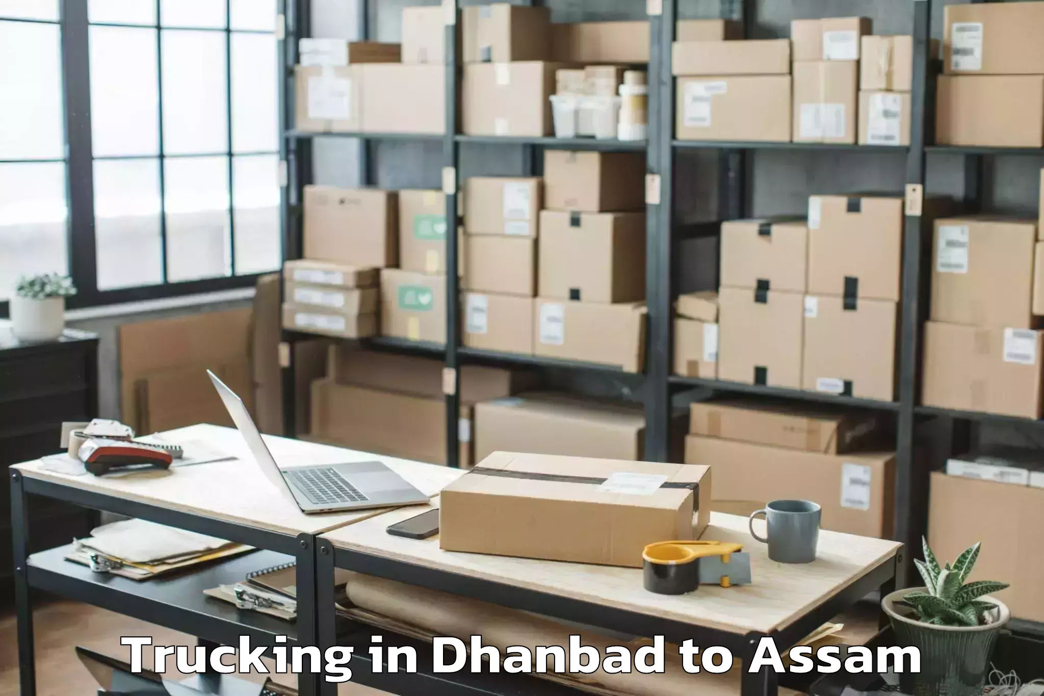 Book Dhanbad to Sualkuchi Trucking